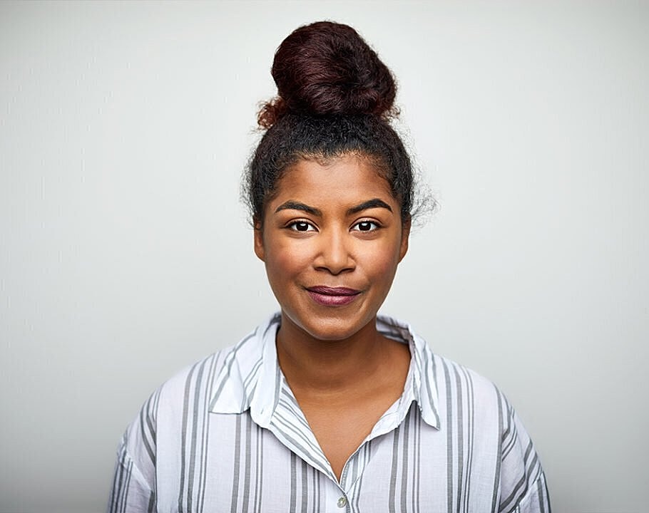 Portrait of a woman with a bun hairstyle.