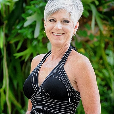 Smiling woman in a stylish black swimsuit.