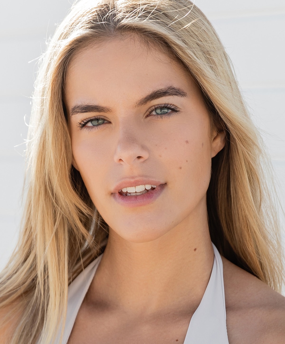 Smiling woman with long, wavy hair.