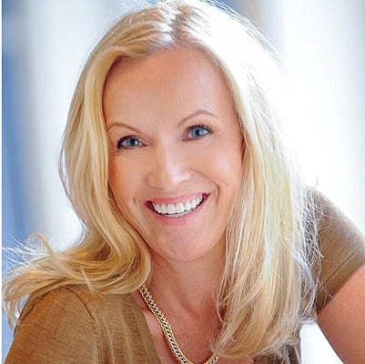 Smiling blonde woman with a warm expression.