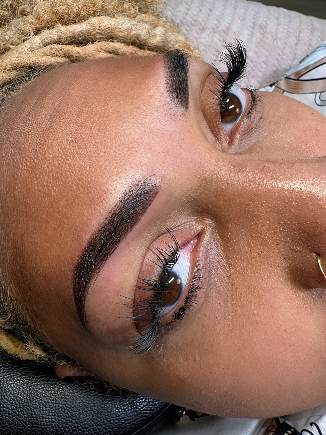 Close-up of eyes with lashes and shaped eyebrows.