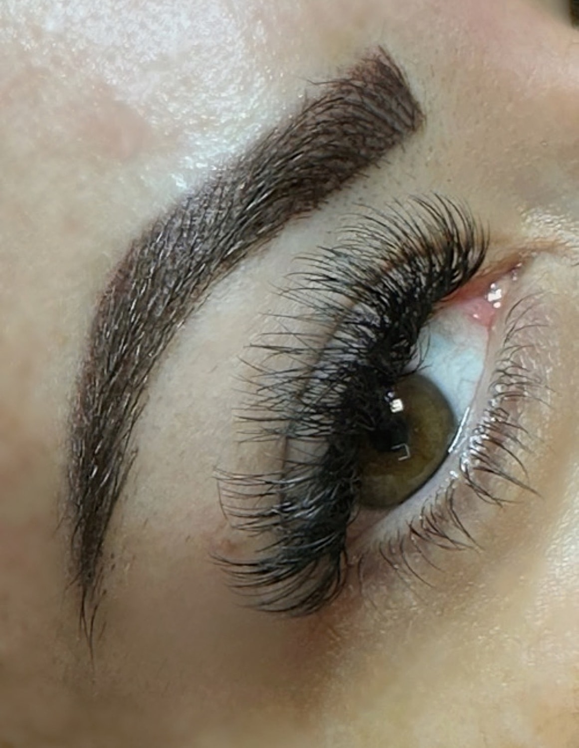 Close-up of eye with eyelashes and eyebrows.