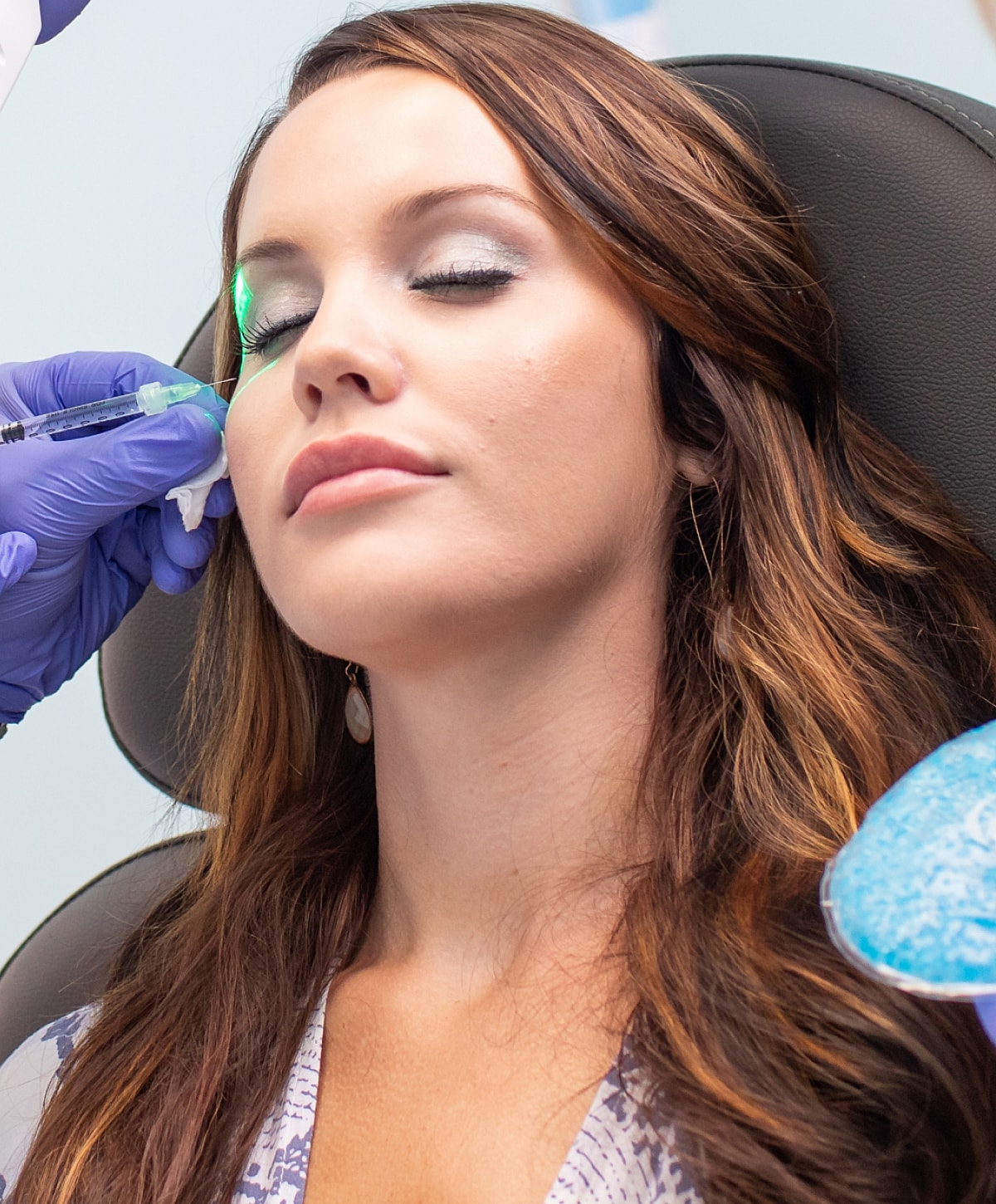 Woman receiving a cosmetic treatment in clinic.