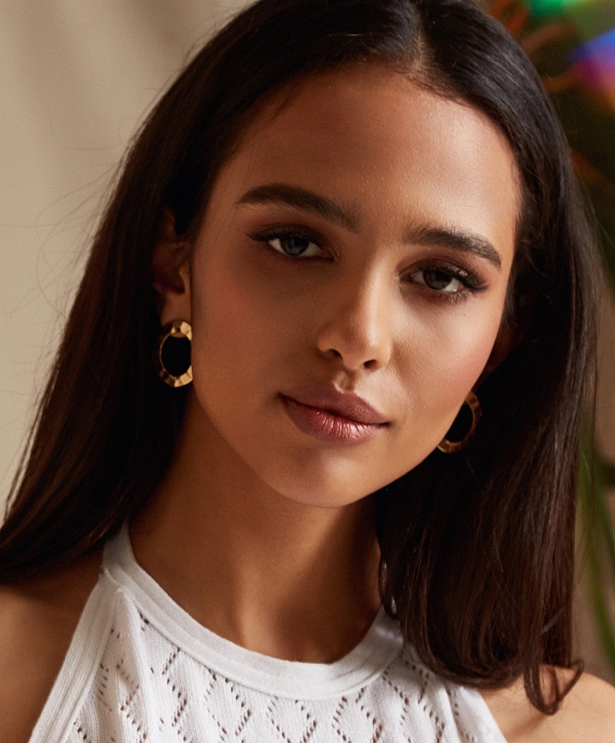Woman wearing sunglasses, relaxing by the pool.