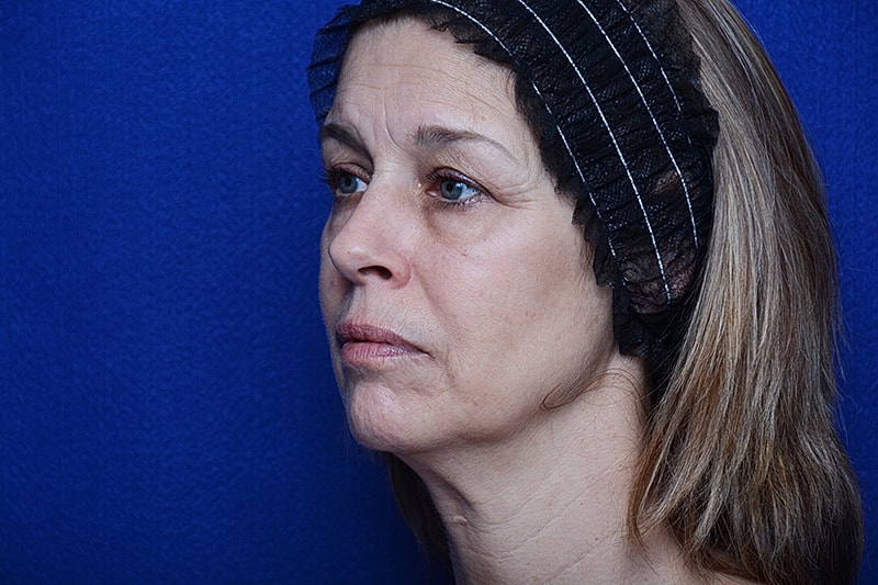 Woman with headband against blue background.