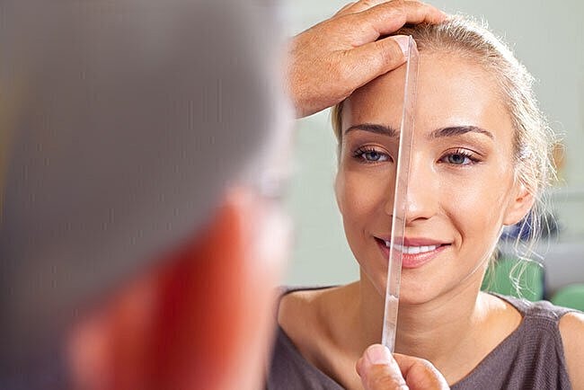 Measuring facial symmetry in a beauty consultation.