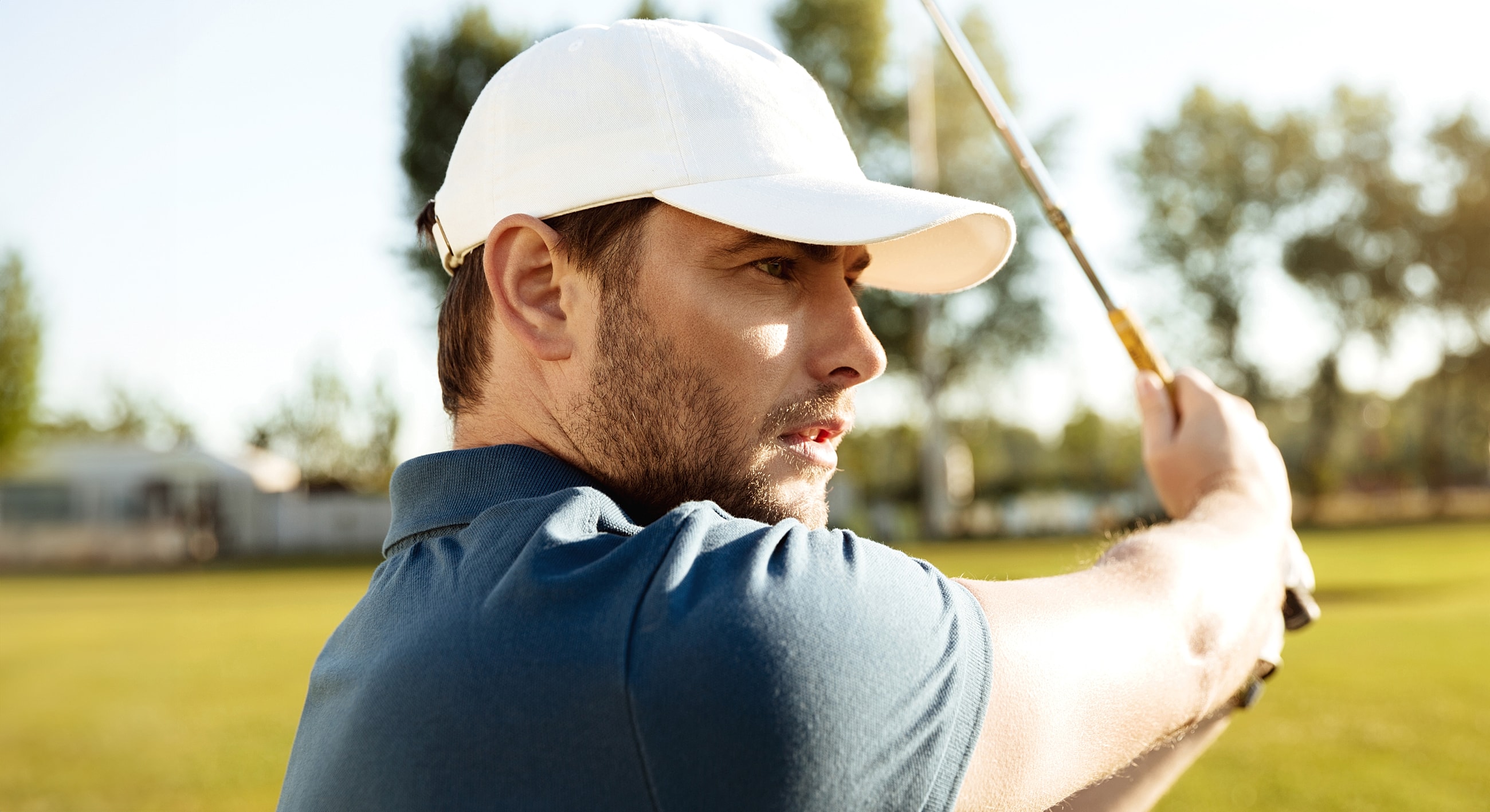 Young woman relaxing outdoors with a serene expression.