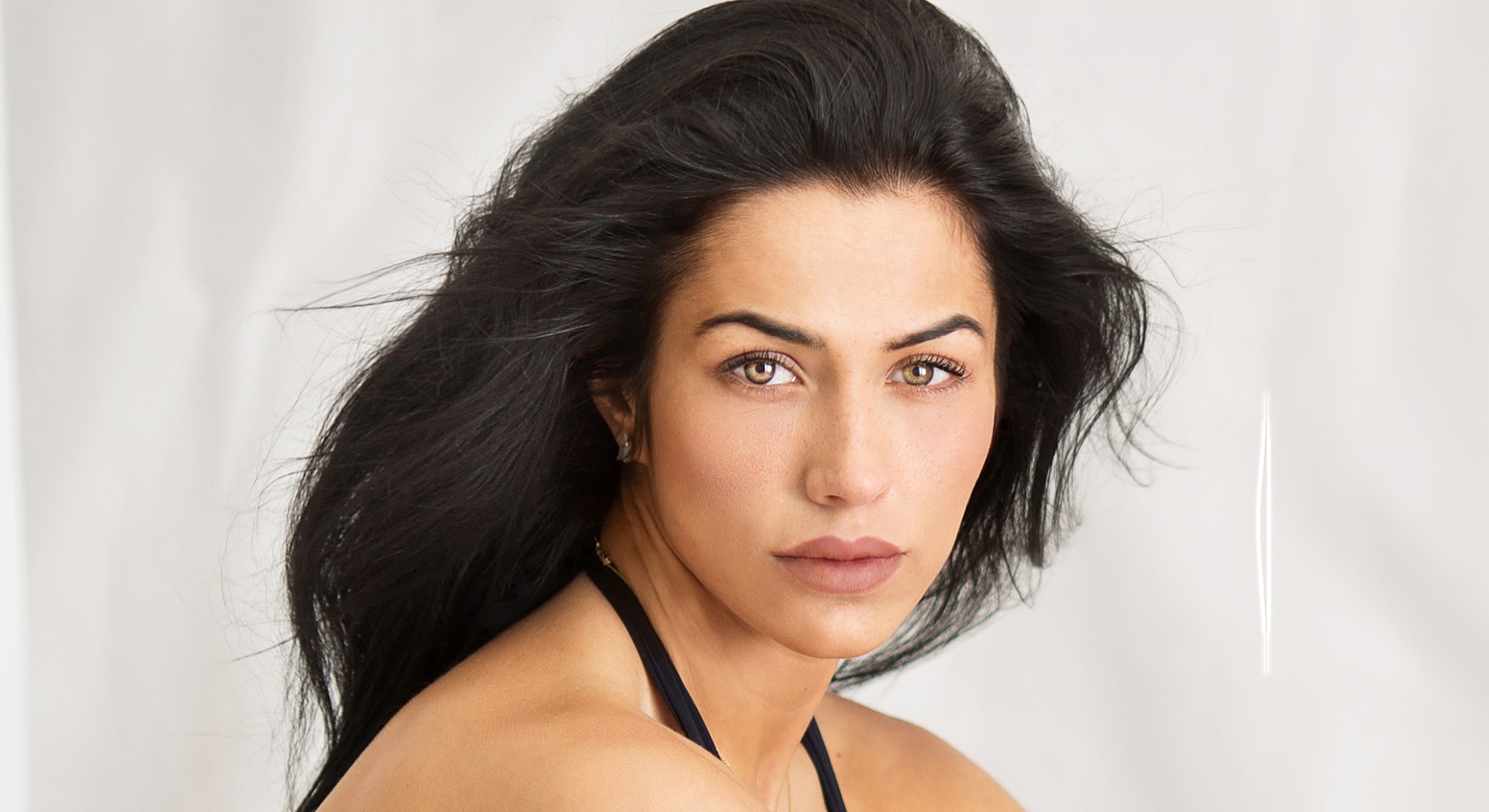 Portrait of a woman with flowing black hair.